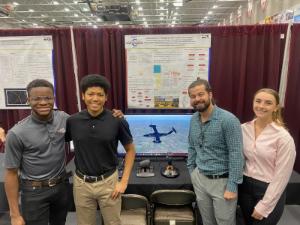 Seniors standing in front of student presentation.